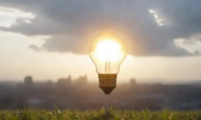 Bombilla de luz brillante con rayos emitiendo de ella
